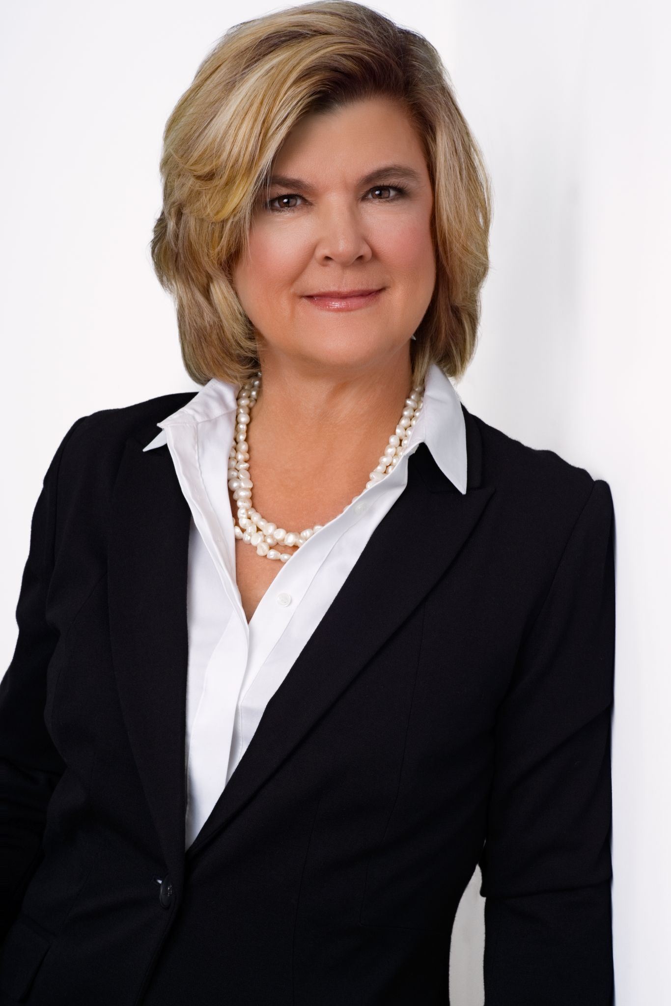 Professional headshot of a Charleston realtor in a blazer, smiling confidently