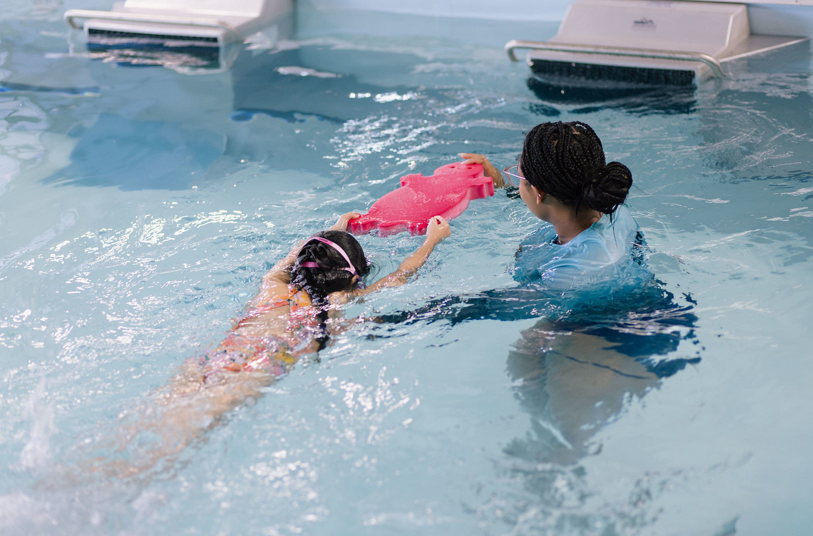 Intermediate swimmer practicing strokes with a coach