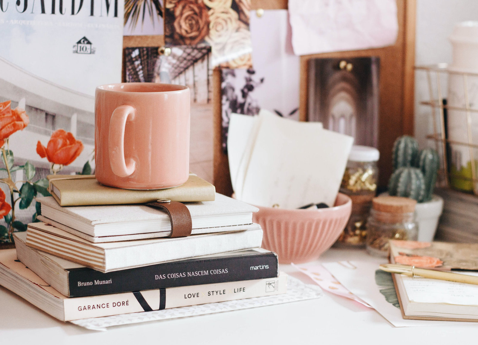 A stack of books on a desk related to design
