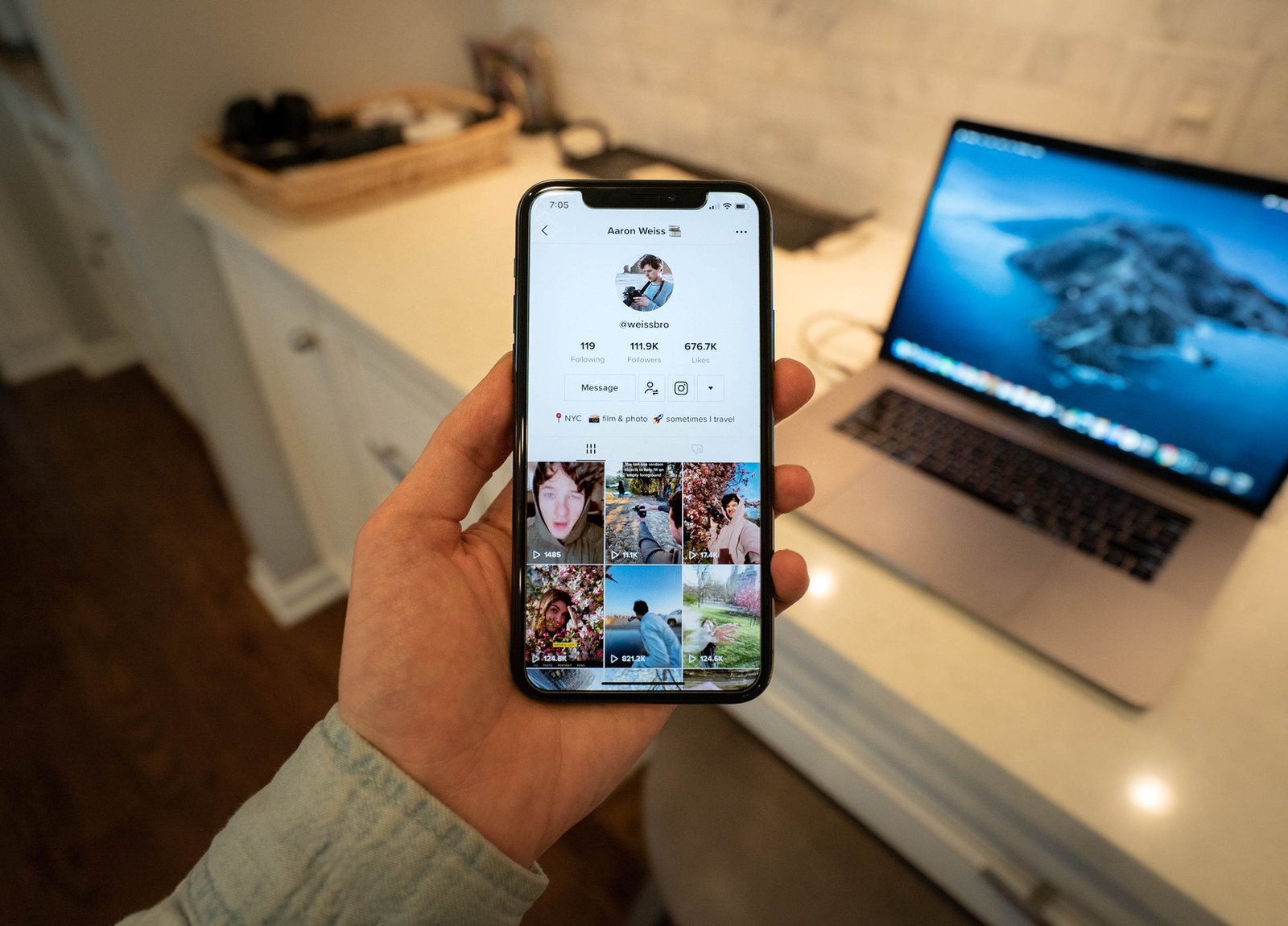 Person holding phone opened to a TikTok account
