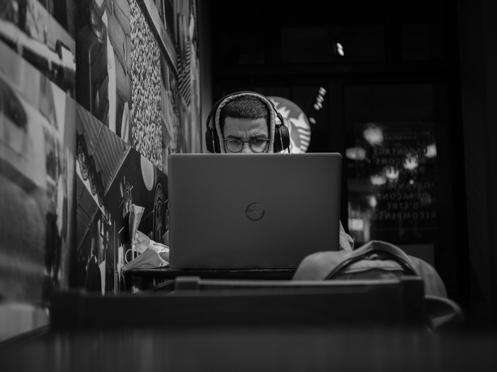 Man on laptop in cafe