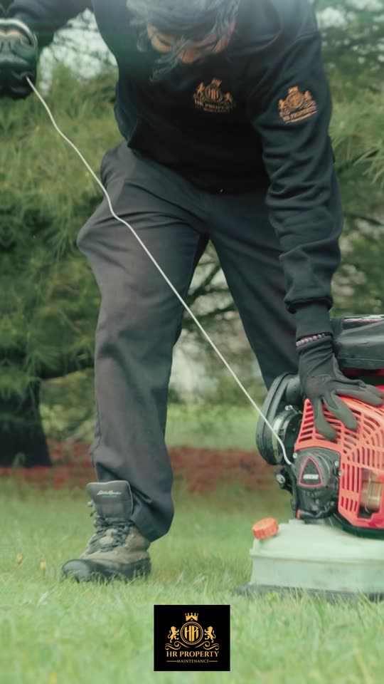 Property maintenance crew trimming a lawn