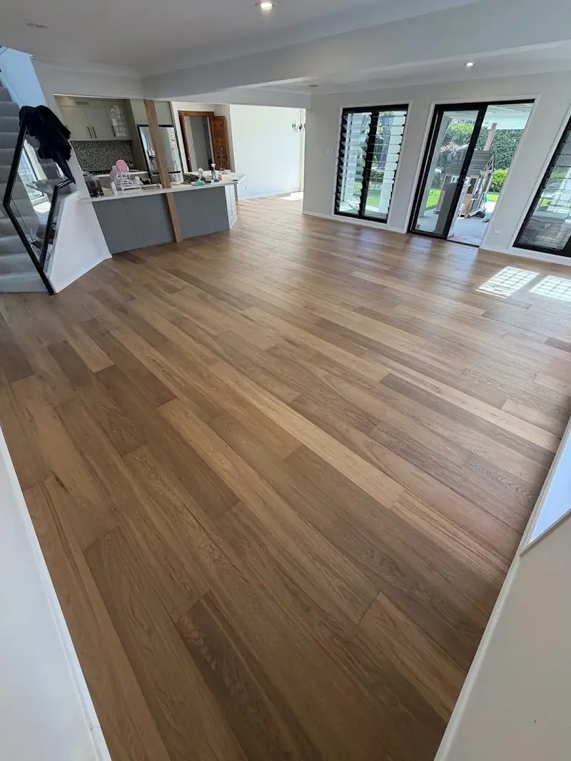 Engineered oak flooring through an open plan living and kitchen area