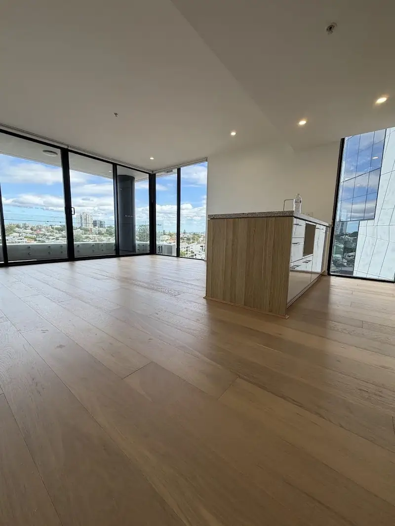 Pale engineered oak flooring in a high rise apartment with city views