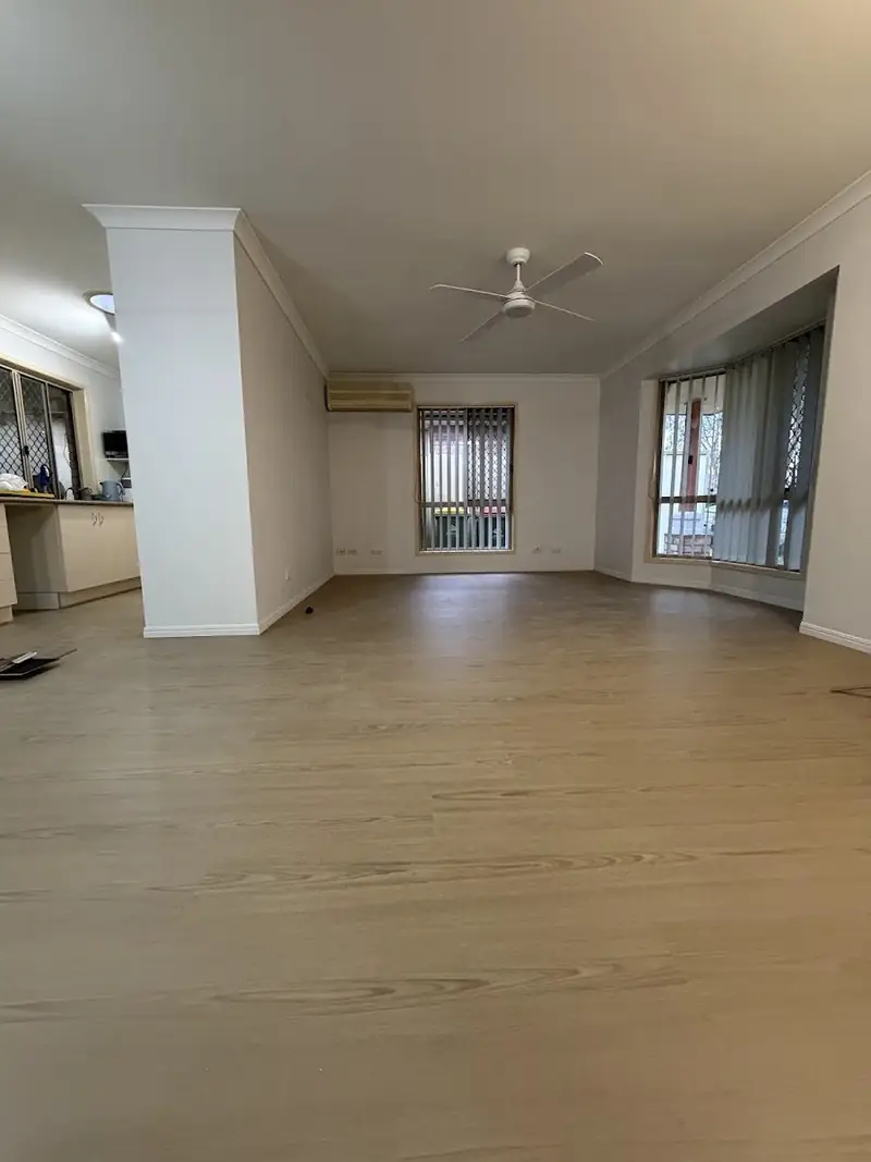 SPC hybrid flooring in a living room with large windows