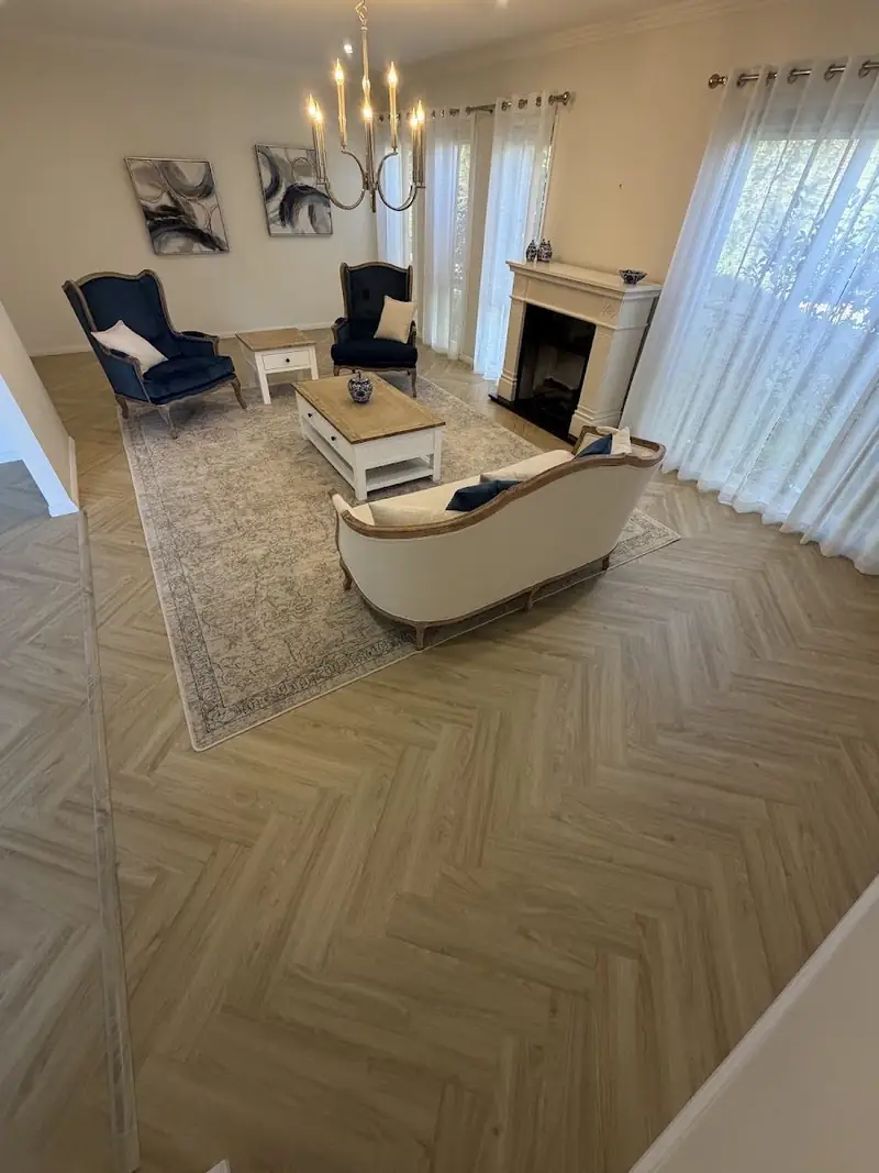 Herringbone flooring in a furnished living room with fireplace