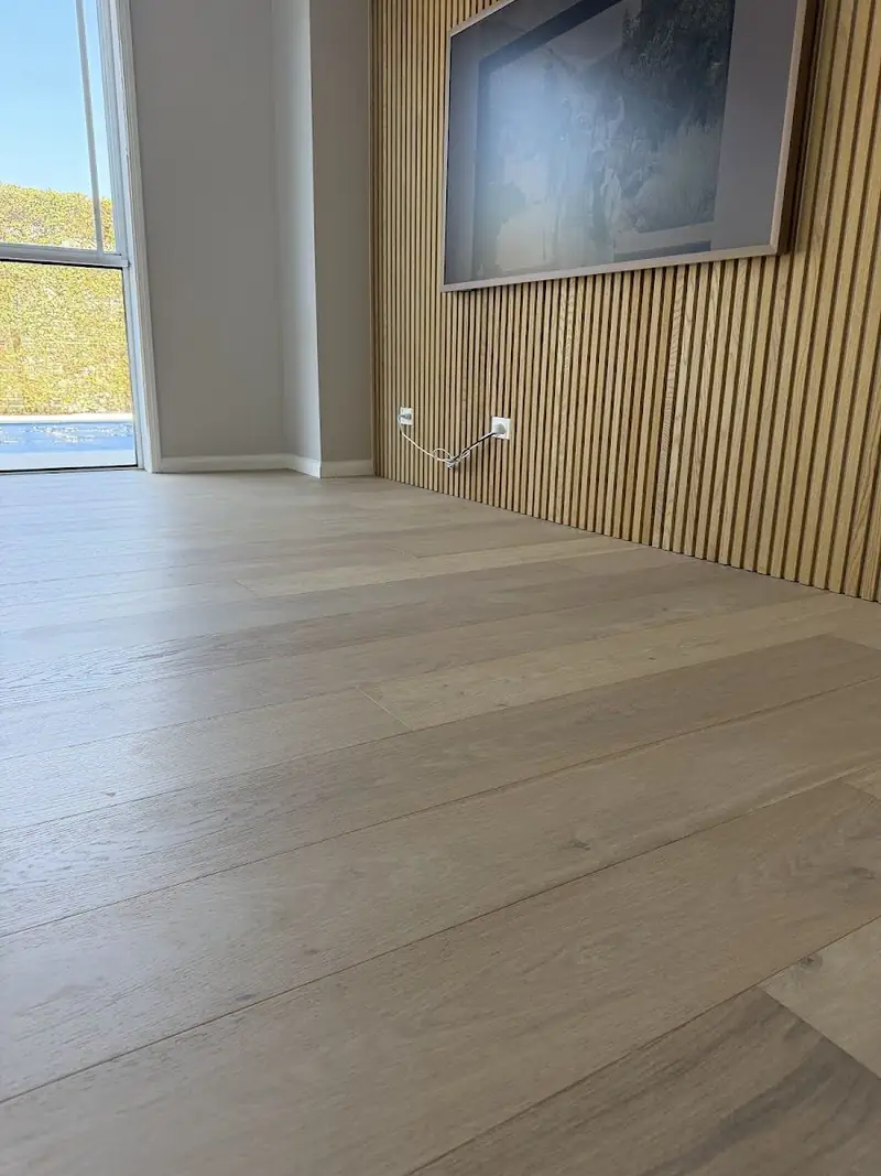 Pale engineered oak flooring beside a timber slat feature wall