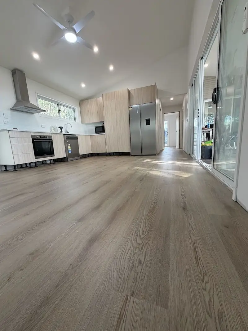 SPC hybrid flooring through a kitchen with downlights