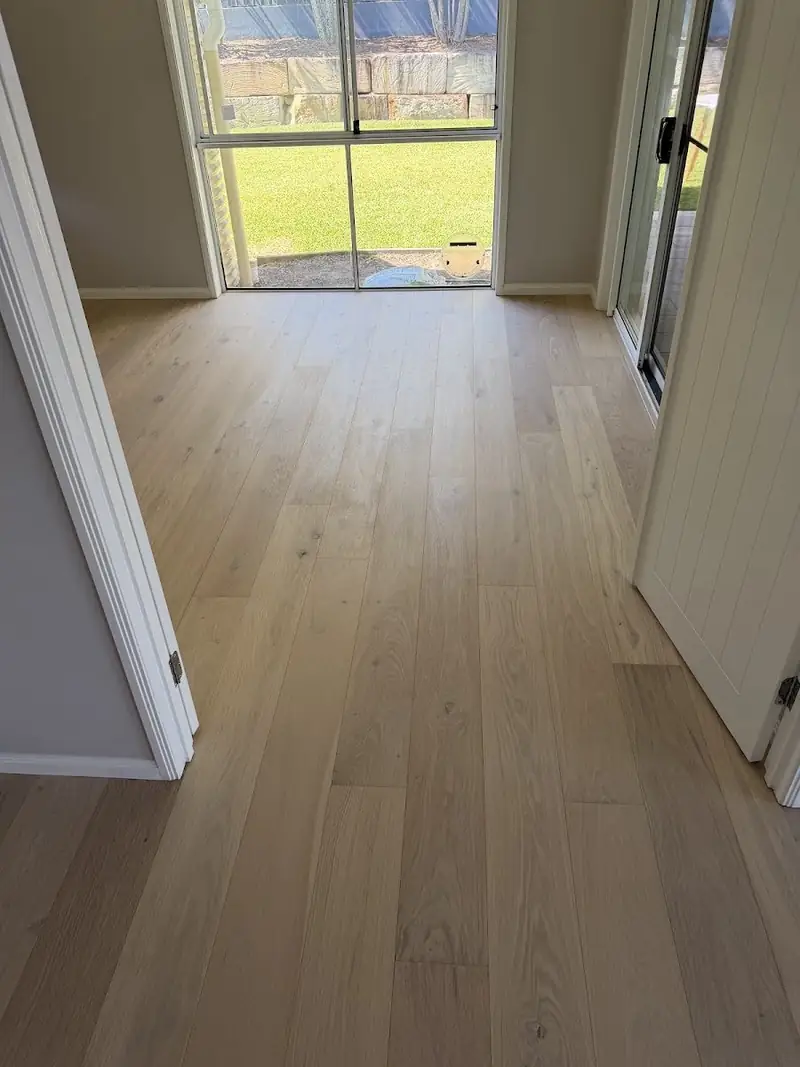 Engineered oak hallway leading to a glass door and garden