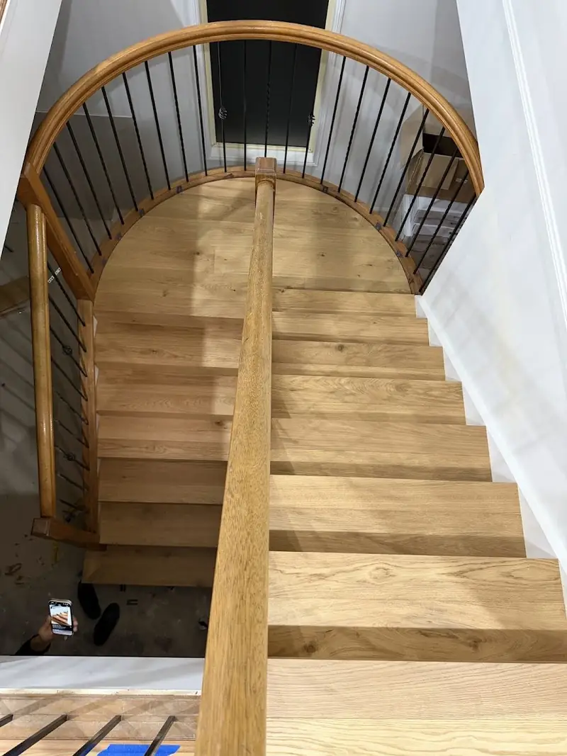 Curved staircase in engineered oak seen from above