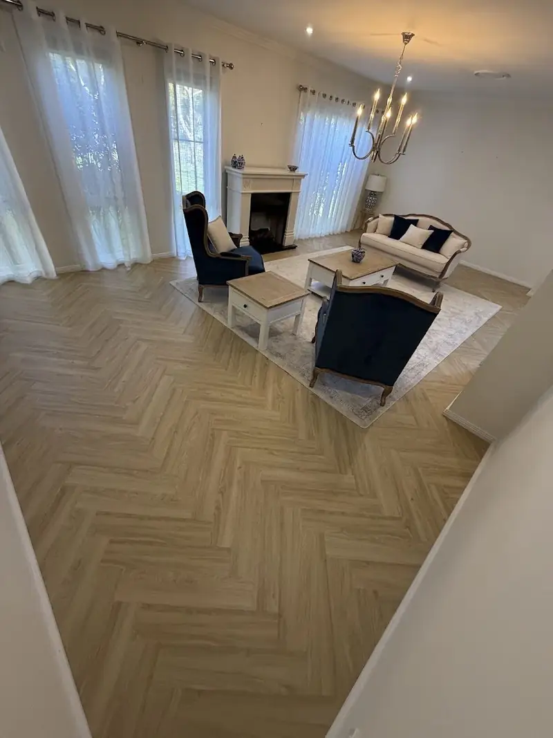 Herringbone flooring across a furnished living room