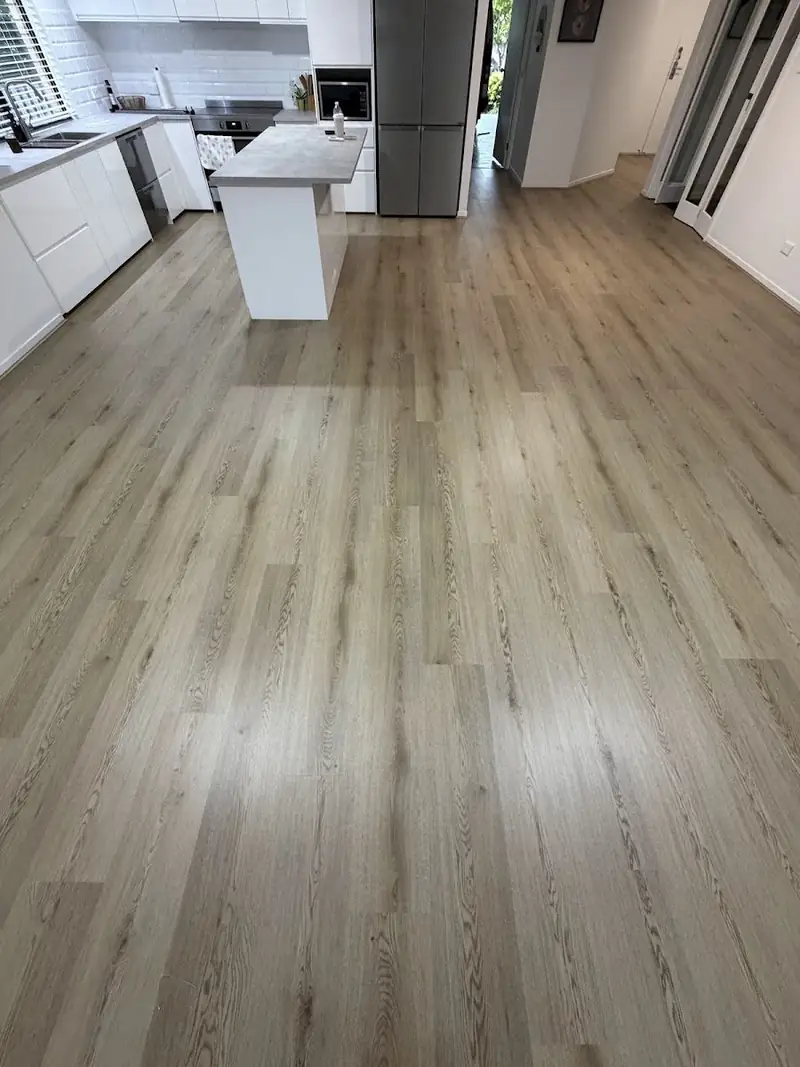 SPC hybrid flooring through a kitchen with island bench