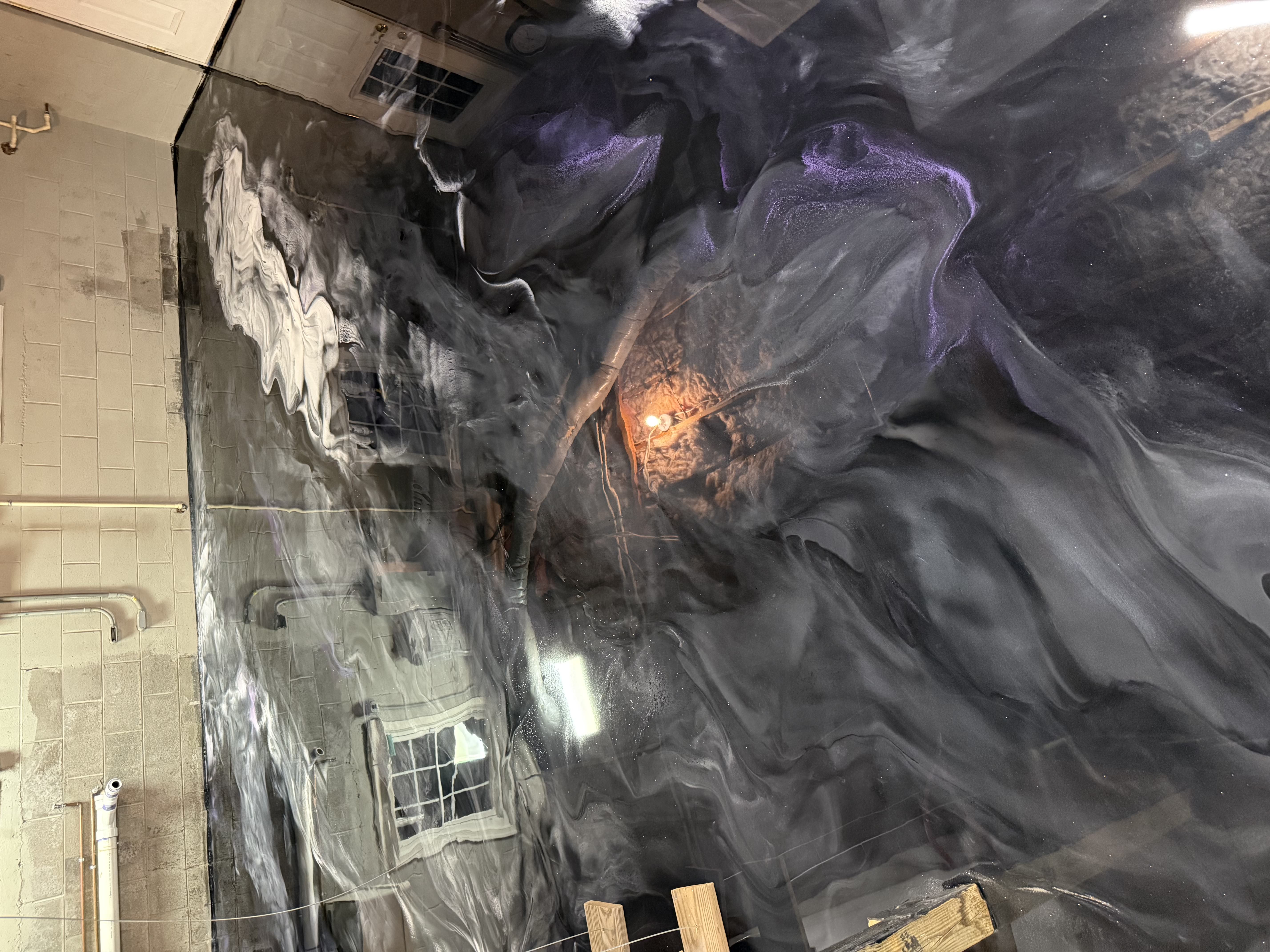 A white car in a garage with a finished floor