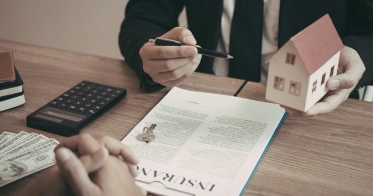 Real estate agent delivering branded listing presentation to potential home sellers.