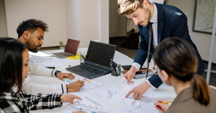 Real estate leadership team analyzing operational infrastructure and performance metrics for scalable growth.