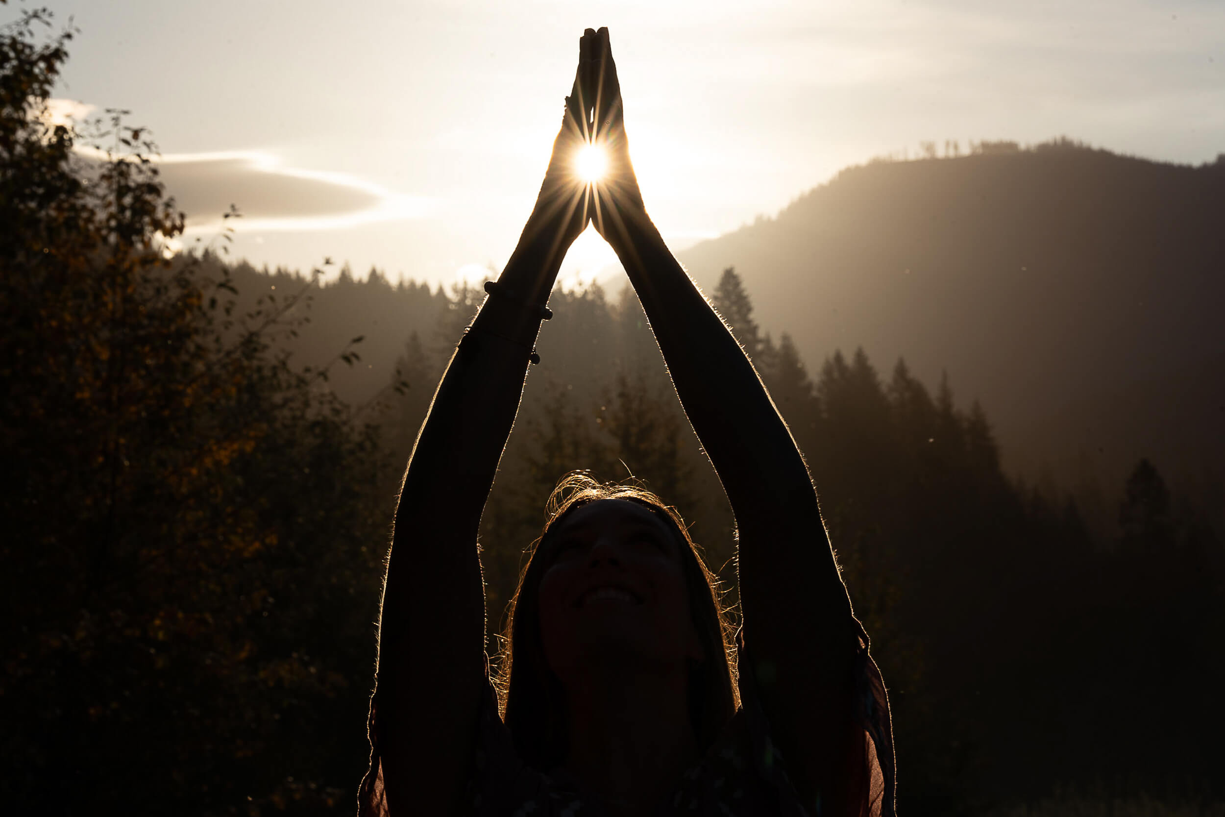 Monochrome image of a dedicated yoga instructor demonstrating an advanced split pose at Shala Yoga studio in Squamish, her tattoos adding to the artistic expression of strength and flexibility