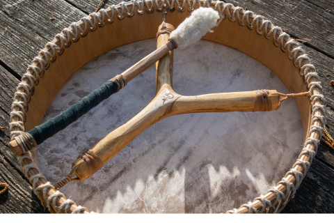 Monochrome image of a dedicated yoga instructor demonstrating an advanced split pose at Shala Yoga studio in Squamish, her tattoos adding to the artistic expression of strength and flexibility