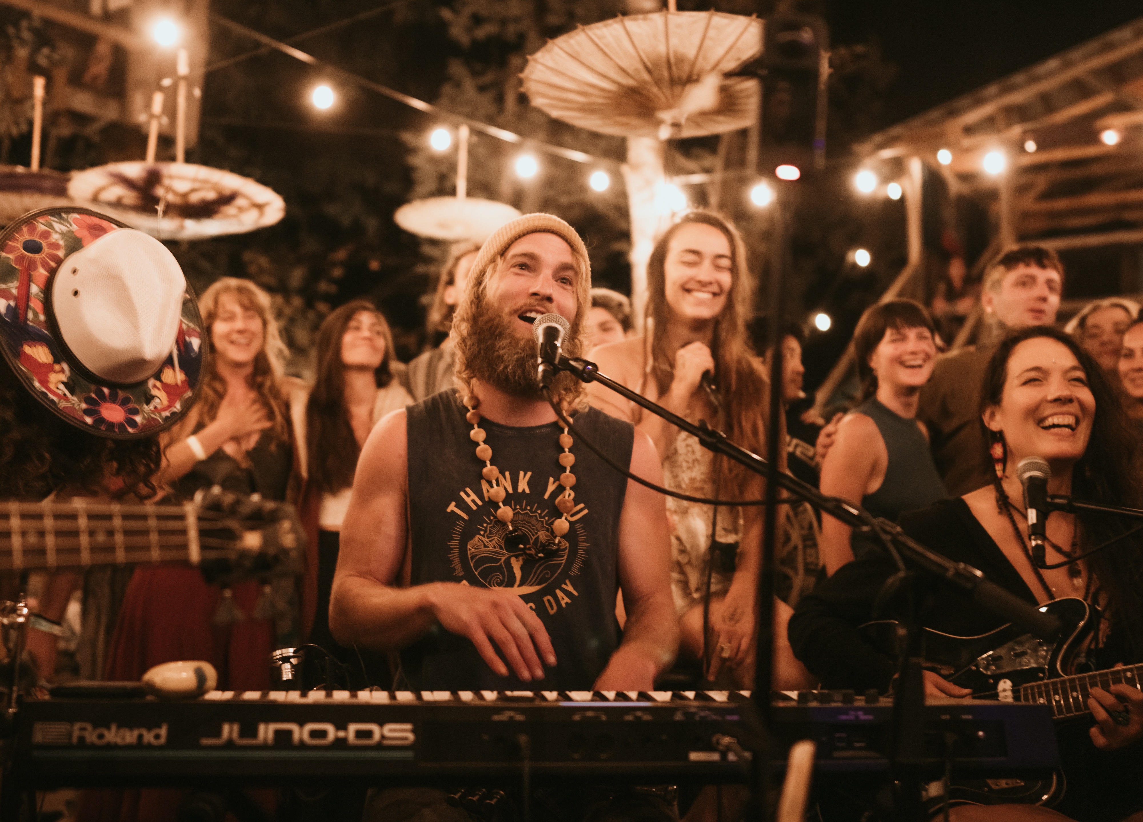 Monochrome image of a dedicated yoga instructor demonstrating an advanced split pose at Shala Yoga studio in Squamish, her tattoos adding to the artistic expression of strength and flexibility