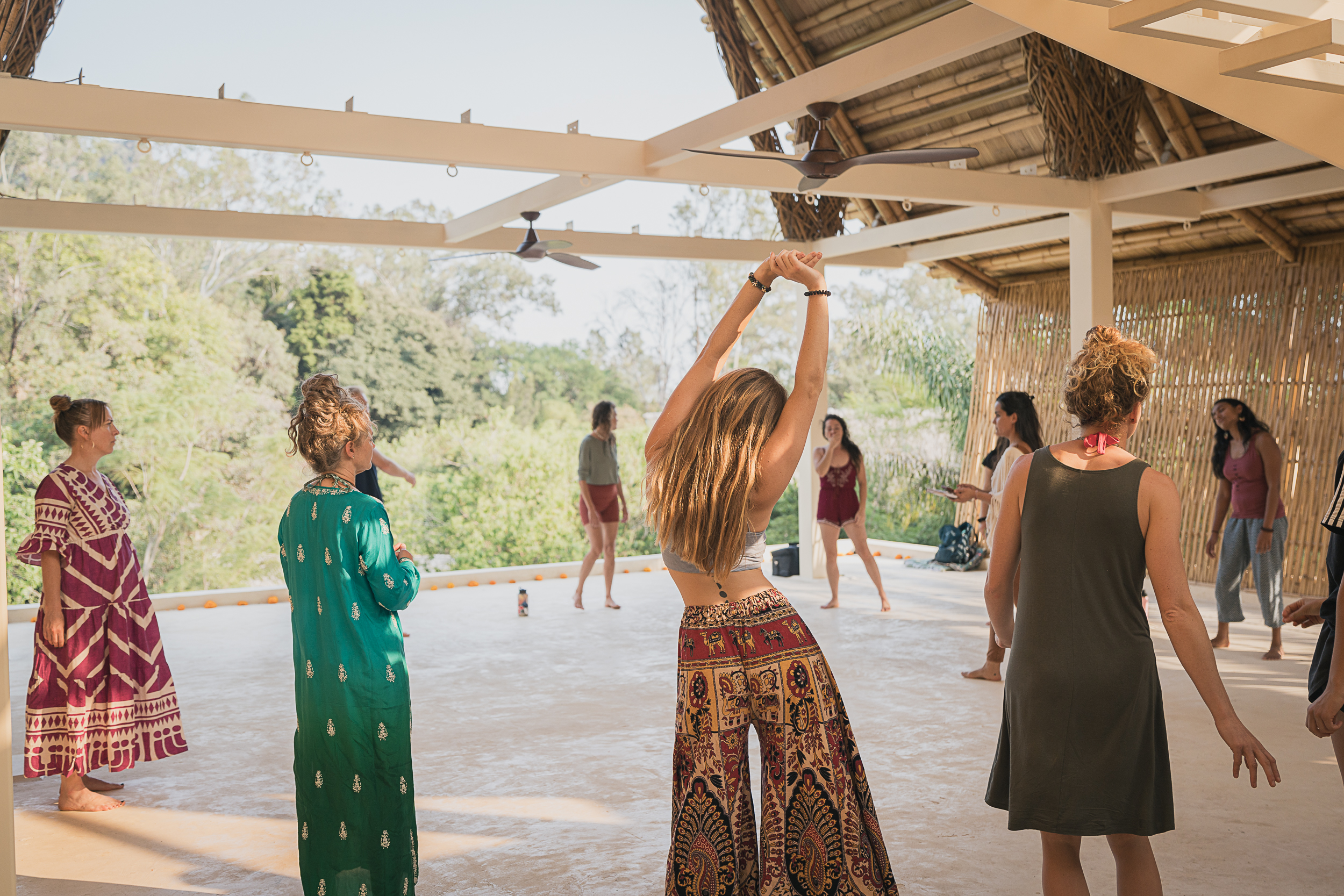 Monochrome image of a dedicated yoga instructor demonstrating an advanced split pose at Shala Yoga studio in Squamish, her tattoos adding to the artistic expression of strength and flexibility