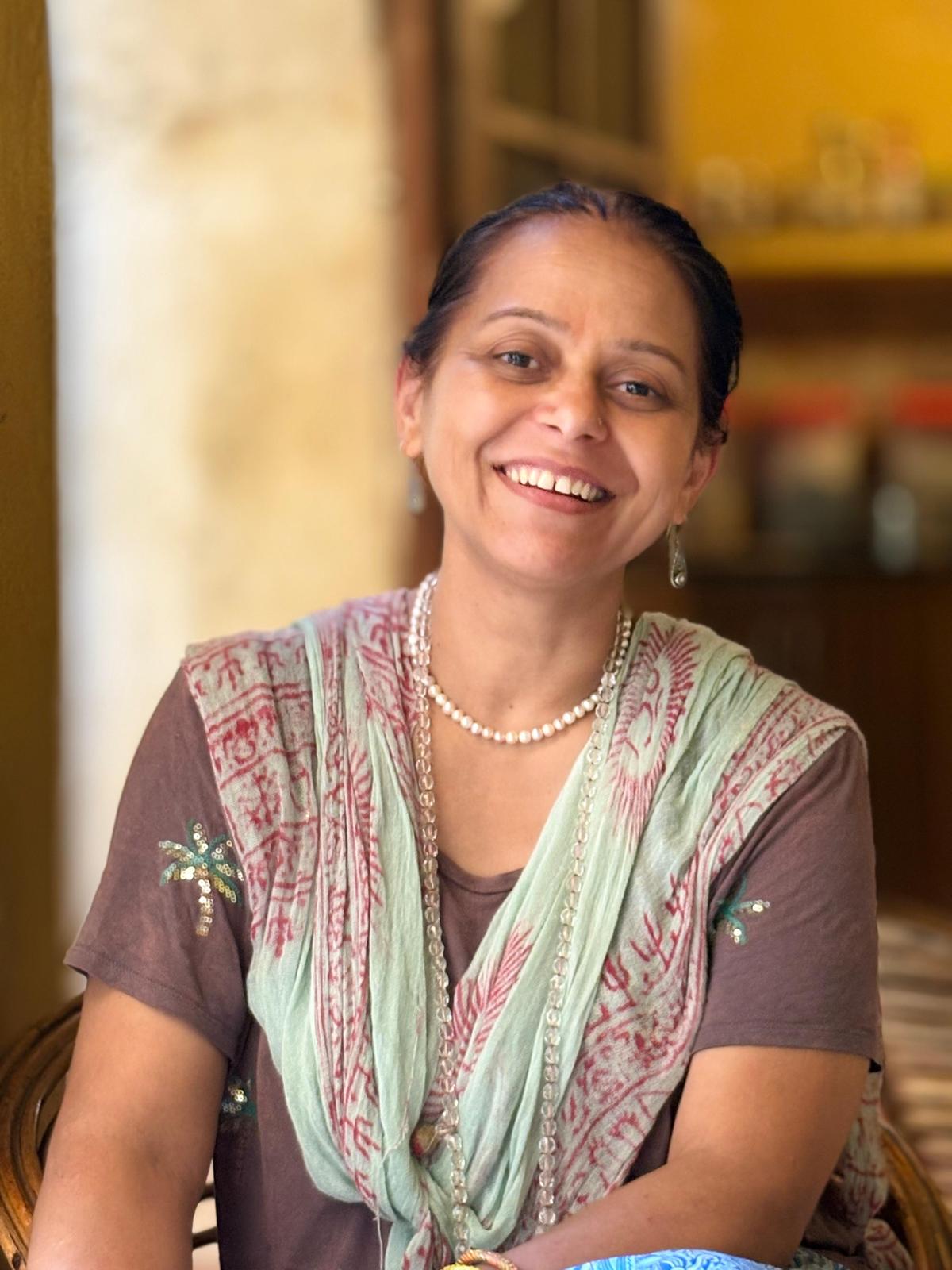 Monochrome image of a dedicated yoga instructor demonstrating an advanced split pose at Shala Yoga studio in Squamish, her tattoos adding to the artistic expression of strength and flexibility