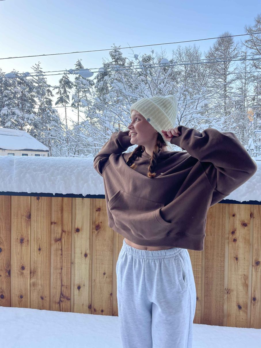 Binge eating nutritionist standing out in snow in foreign country
