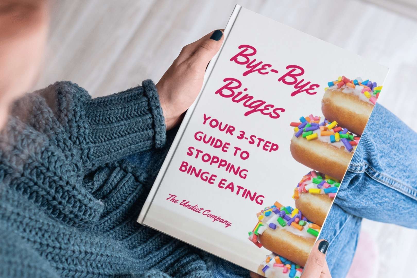 Woman holding Bye Bye Binges hard cover book in her lap