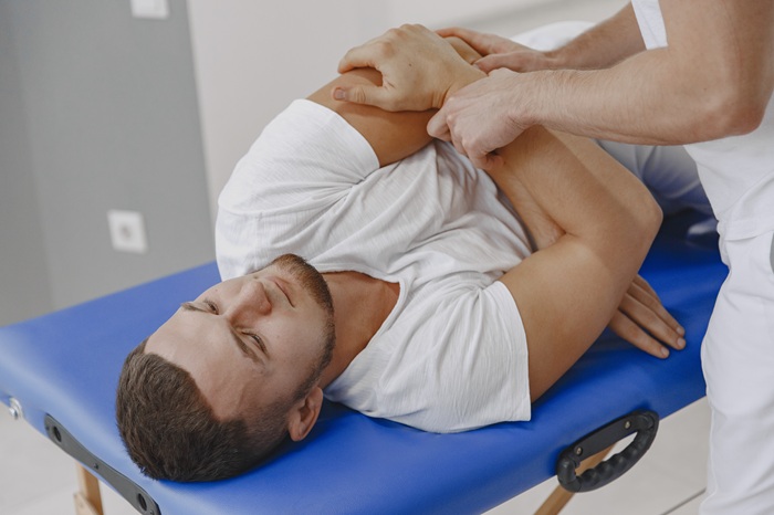 Chiropractor performing hands-on spinal adjustment on patient in Fountain Valley CA
