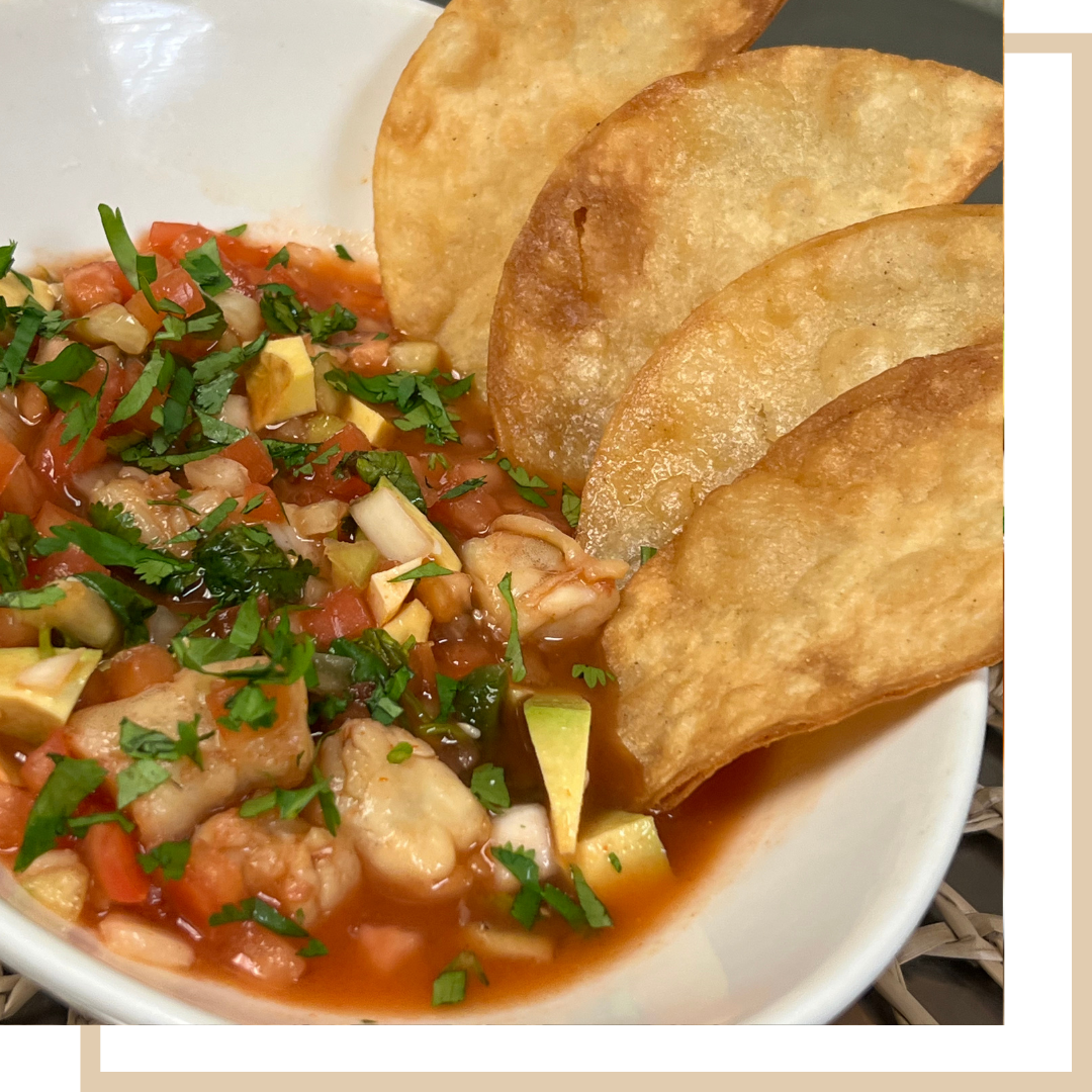 Shrimp Ceviche - Citrus-marinated shrimp layered with avocado and hot sauce, served on two crispy tostadas
