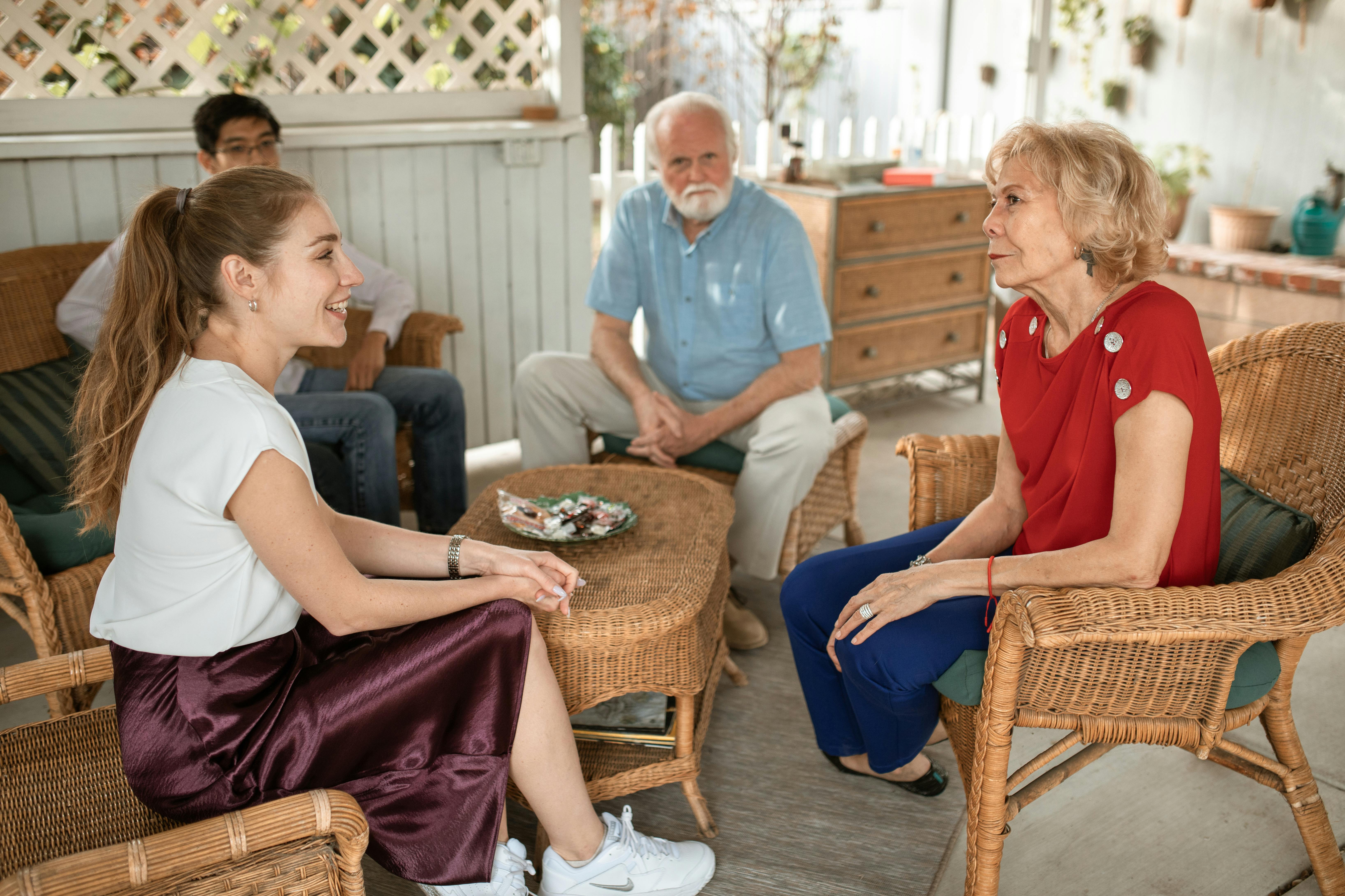 A relaxed conversation on a sunlit front porch