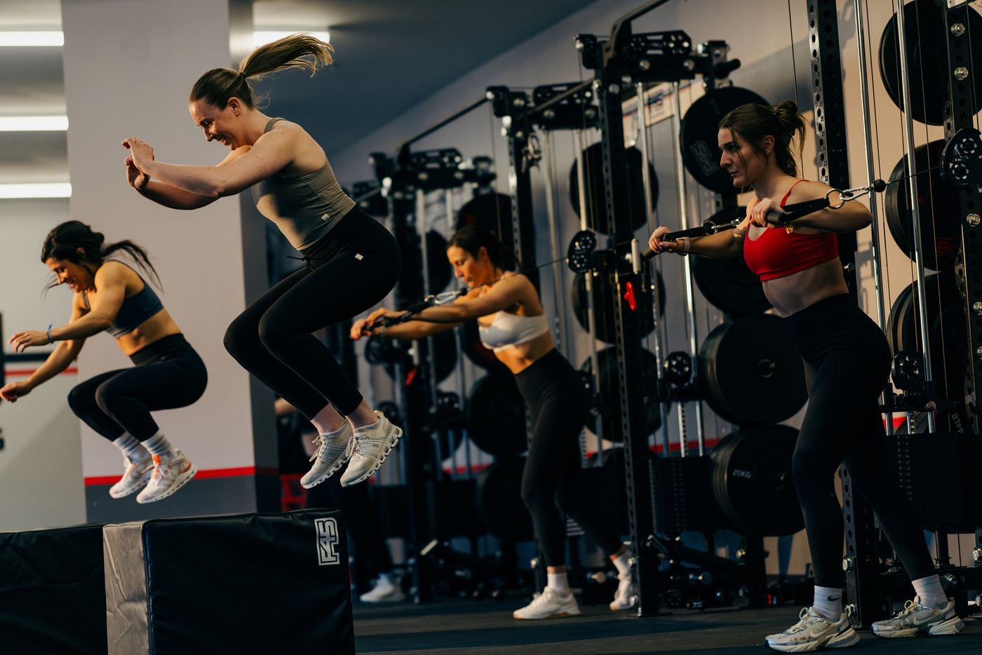 F45 members mid-class — box jumps and cable work on the training floor