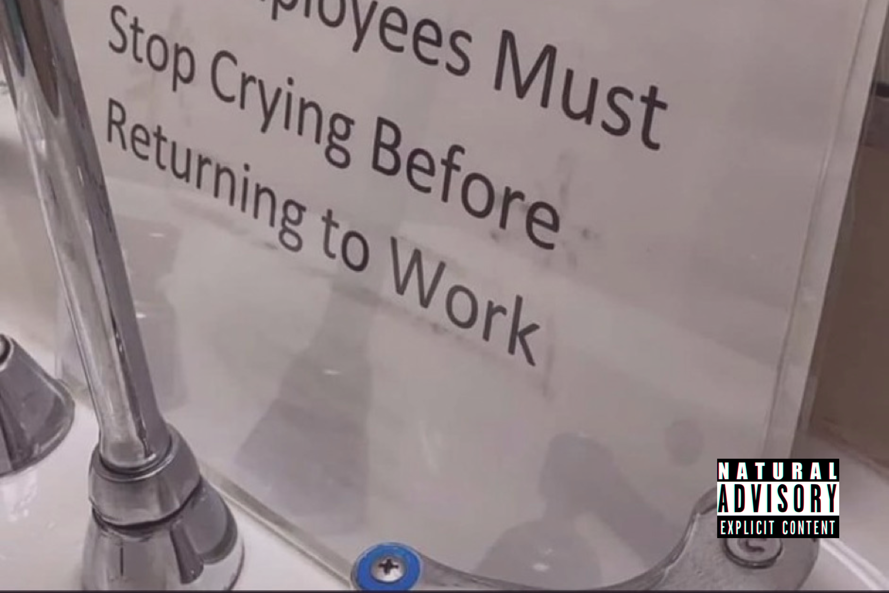 Bathroom sign behind sink faucet that says “All employees must stop crying before returning to work” with the Natural Advisory, ND watermark