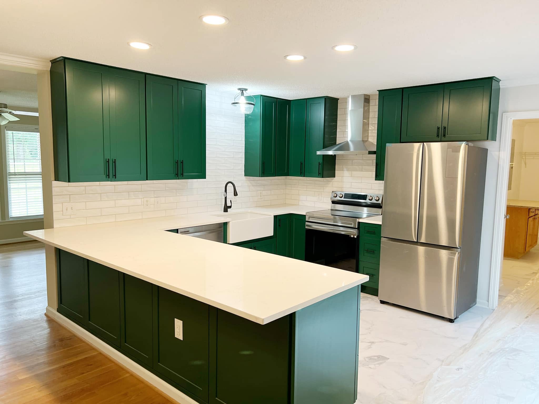 Kitchen after renovation with white cabinetry and large
island