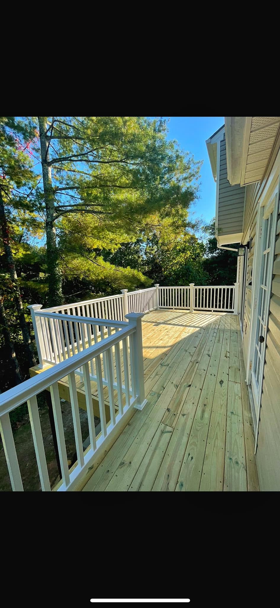Deck after renovation with new boards and railings