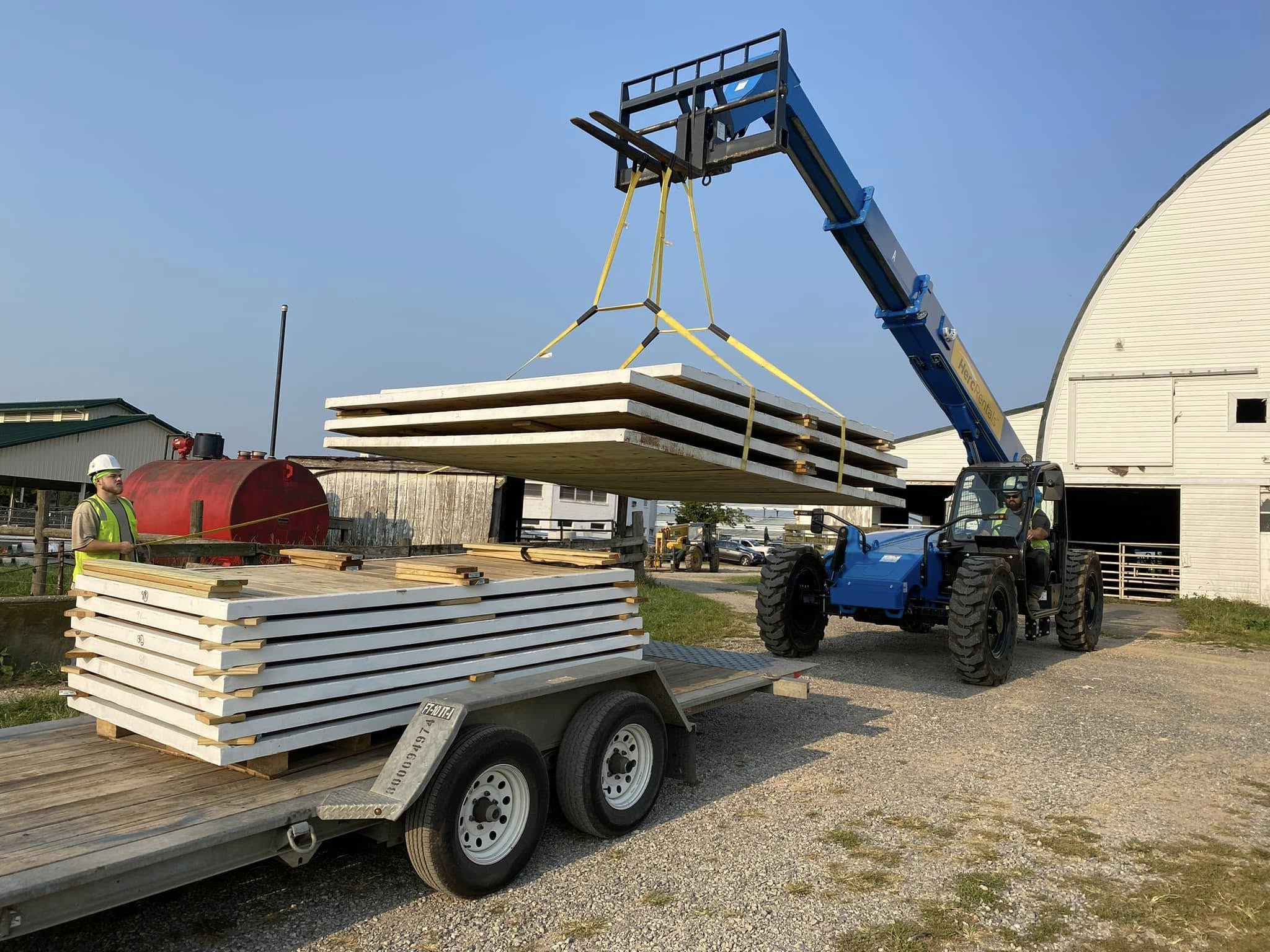 Momentum Building crew moving large construction panels with a
telehandler