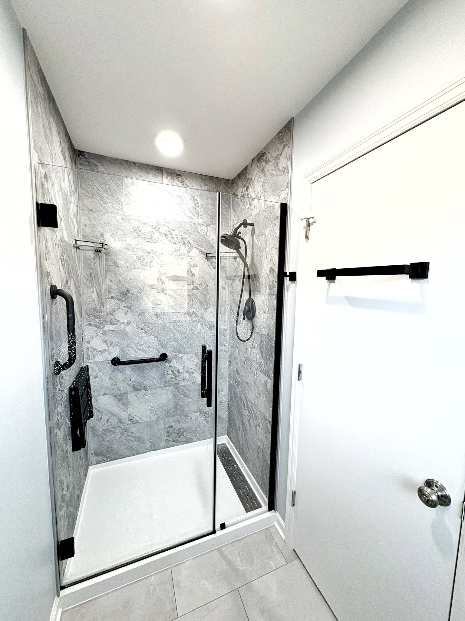 Accessible tiled shower with grab bars