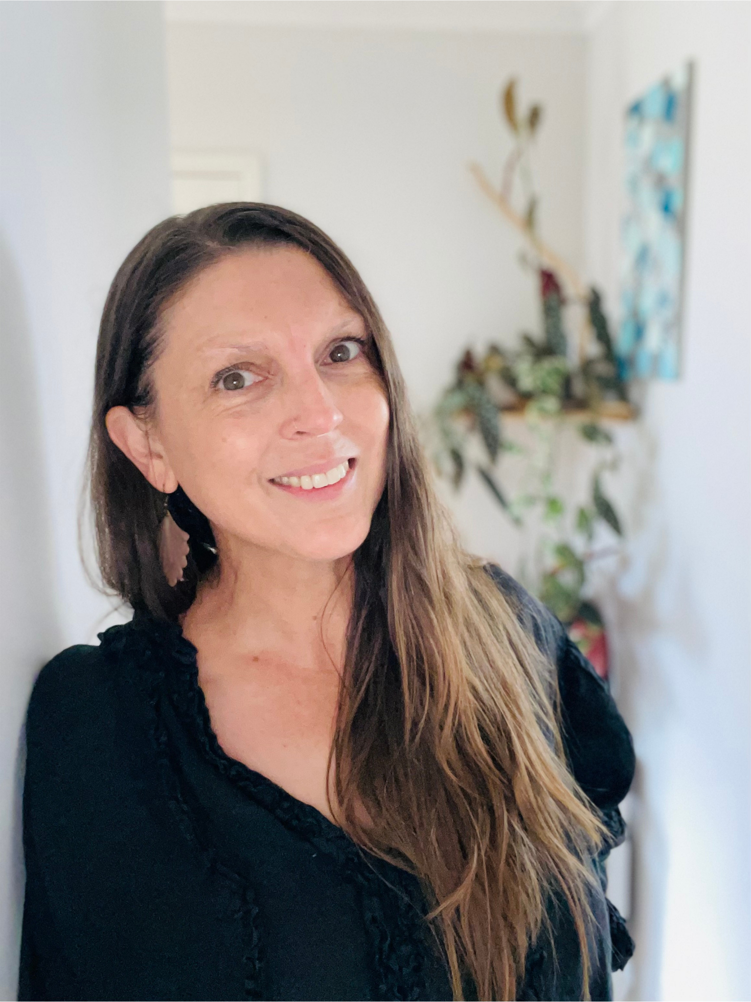 WOMAN SMILING IN HALLWAY