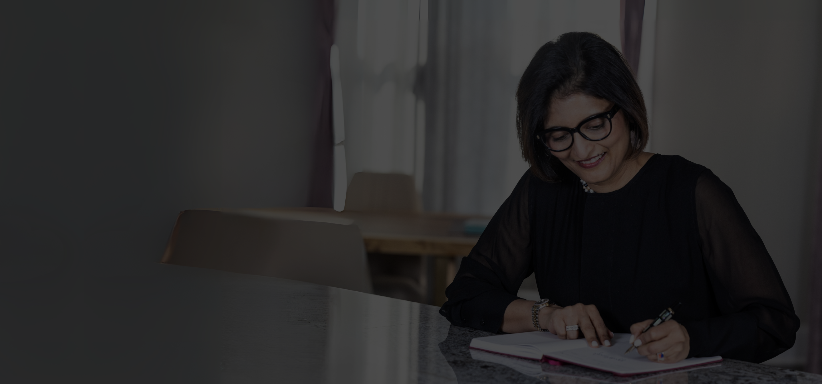 Anagha Deshmukh working at a desk