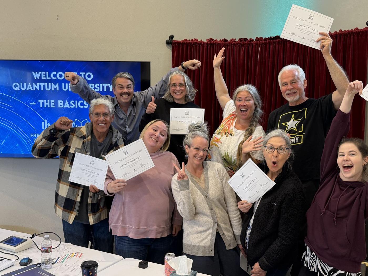 A Quantum Biofeedback University class celebrating with their certificates