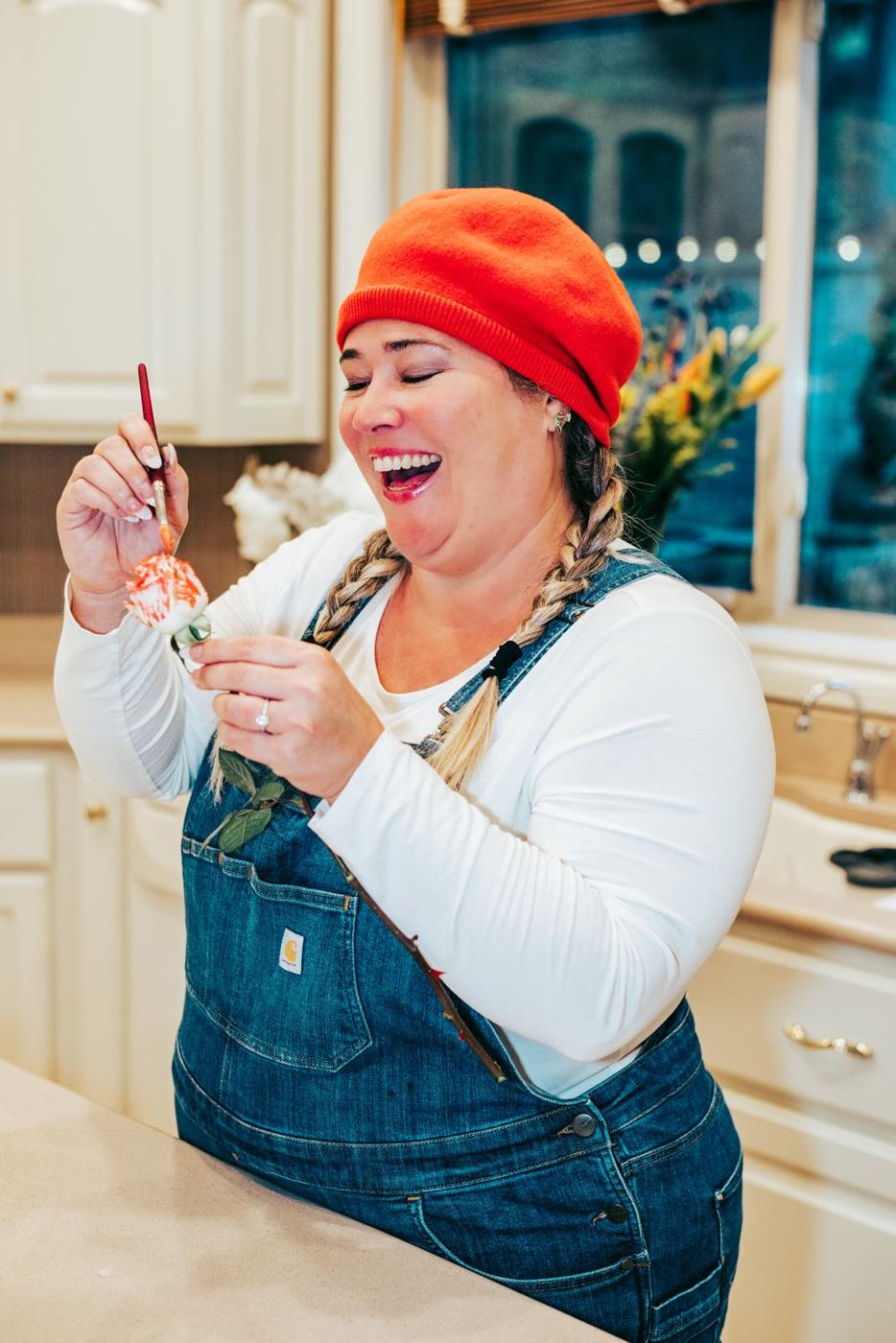 Kathryn Belleville painting in her kitchen, laughing
