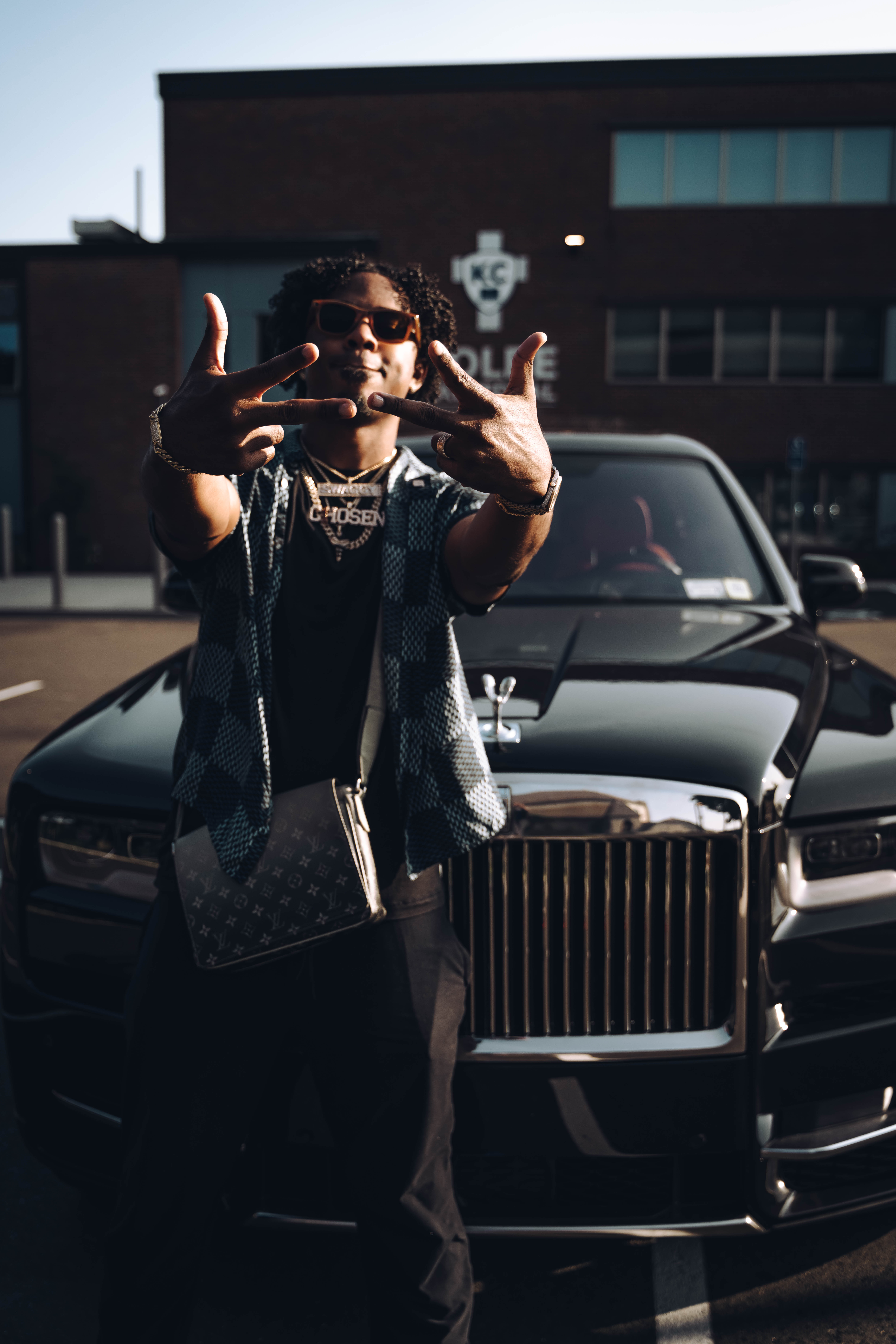 Chris now, standing in front of a black Rolls Royce.