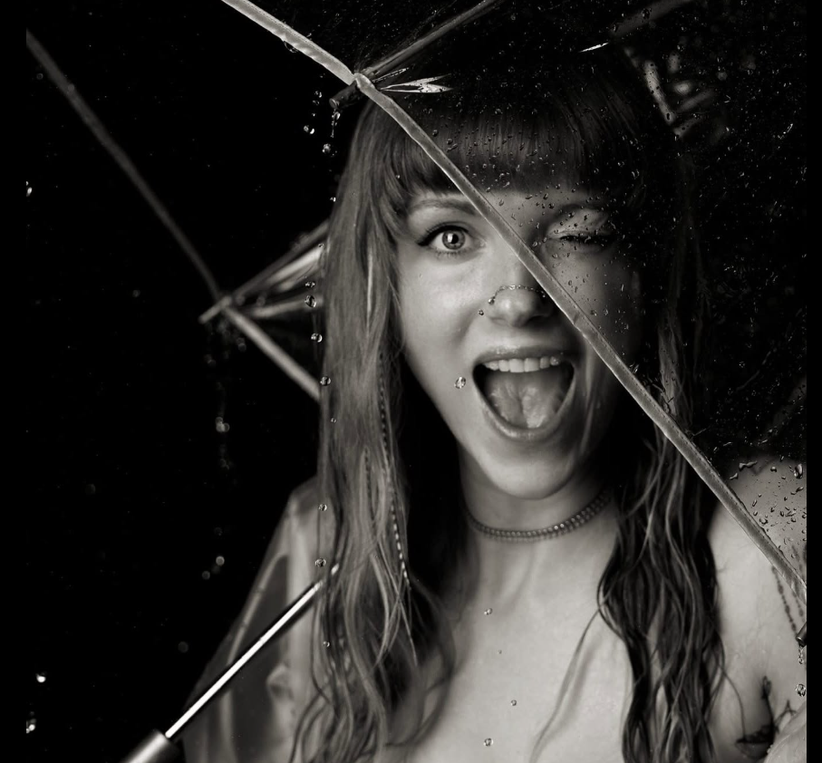 Sapphire making a playful face in a black-and-white photograph