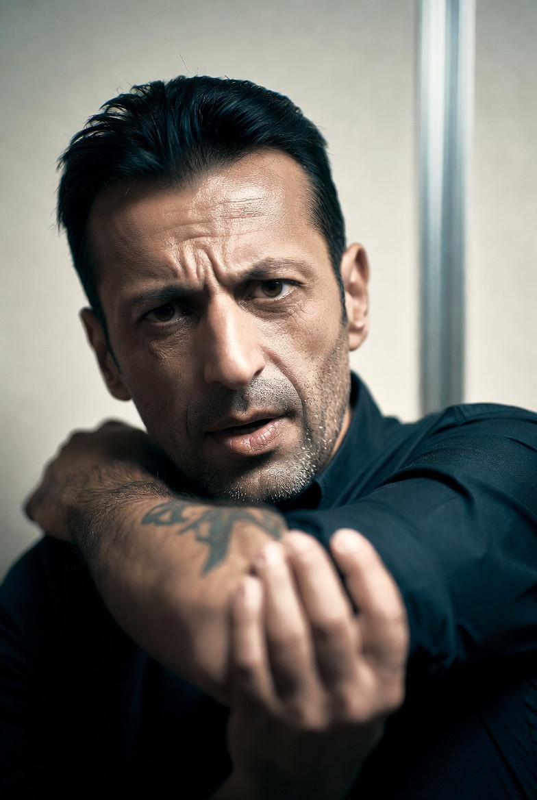Man holding his outstretched arm, numbness radiating from the neck