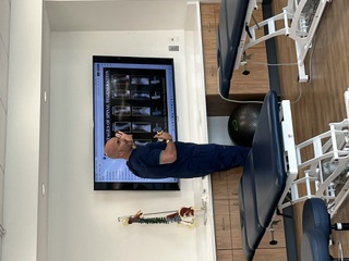 Dr. Lenny Roberts presenting the stages of spinal degeneration at Jefferson University