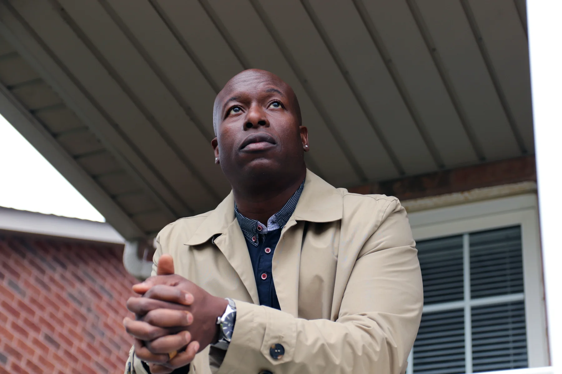 Ian Webster wearing a tan coat