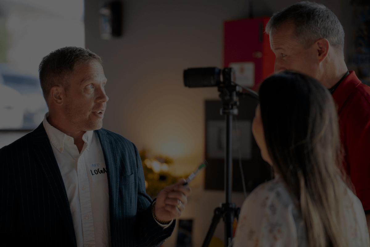 Logan Fullmer discussing real estate investing with attendees at an event