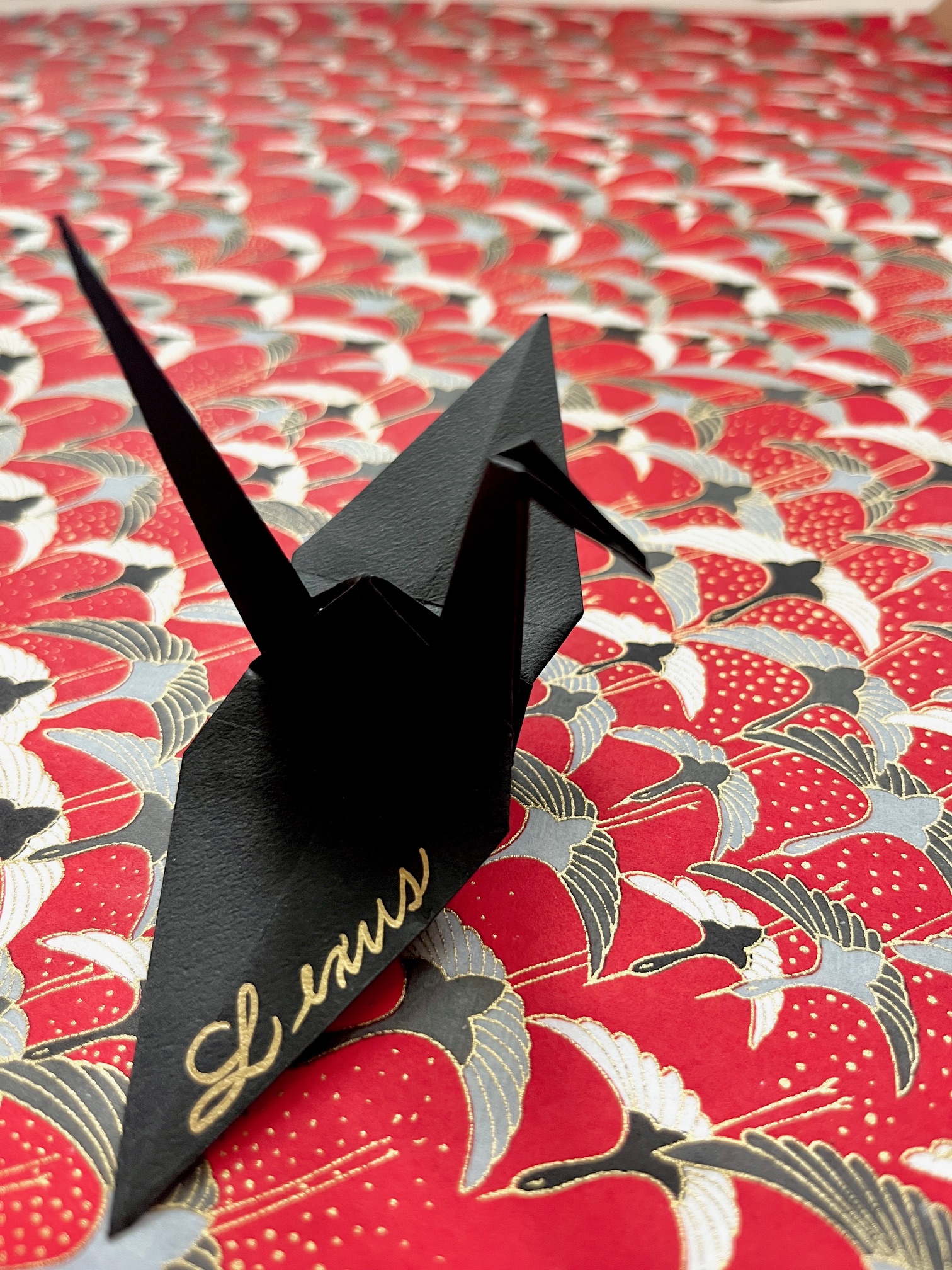 Origami swan created from calligraphy practice pages by Janet Murata