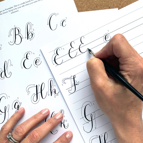Teen practicing pointed pen calligraphy with dip pen and ink