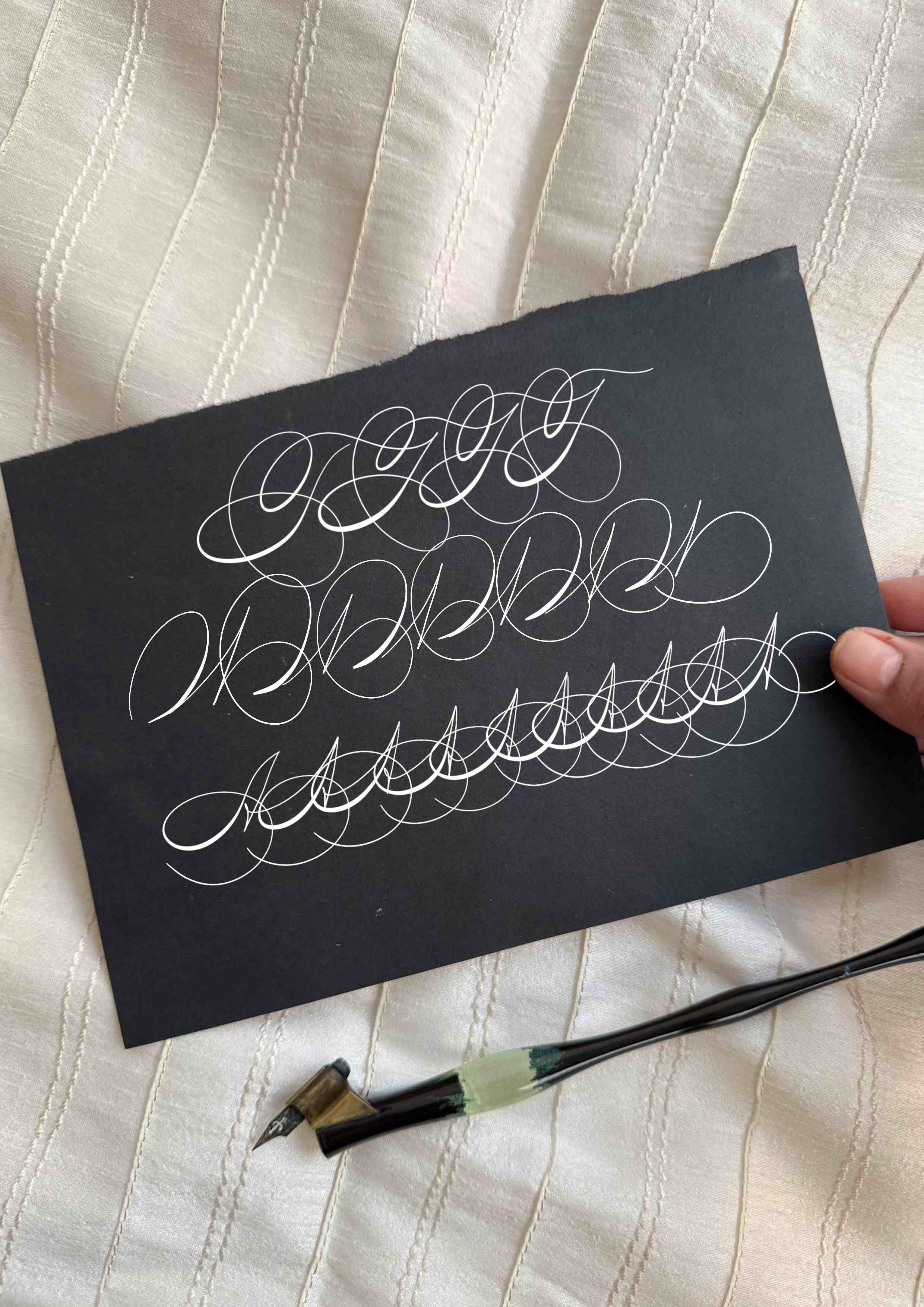 Flourished Spencerian signature sample by Lavina Jhangiani, white ink on black cardstock