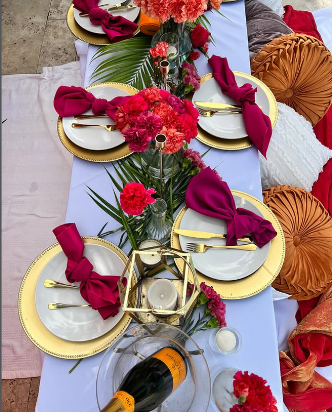 Styled beach picnic with cushions and champagne