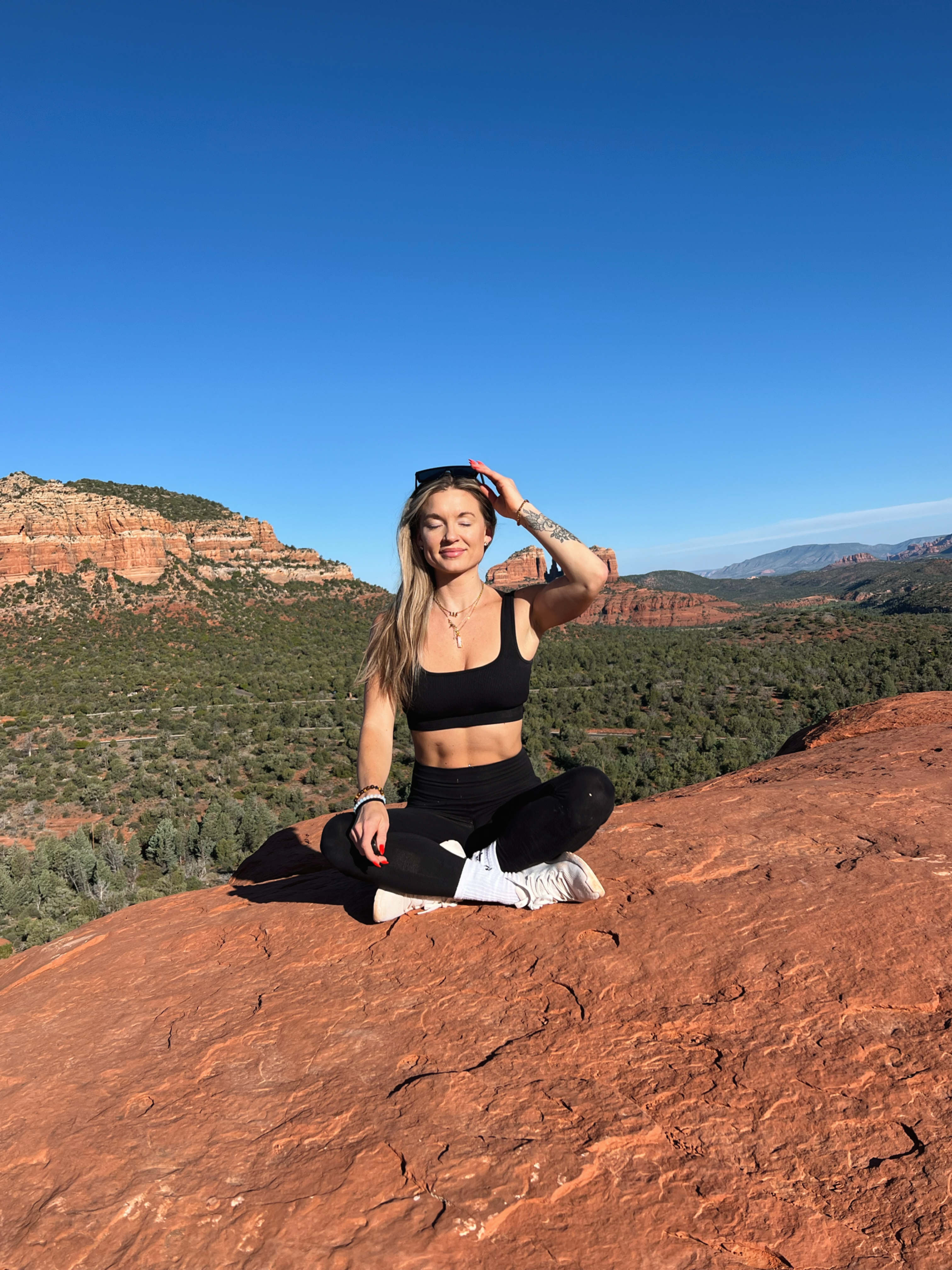Mary Hope sitting on a Sedona vista with eyes closed in stillness